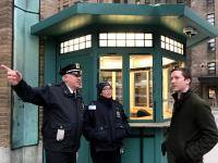A public safety officer provides directions at the booth on 168th Street and Fort Washington Avenue.